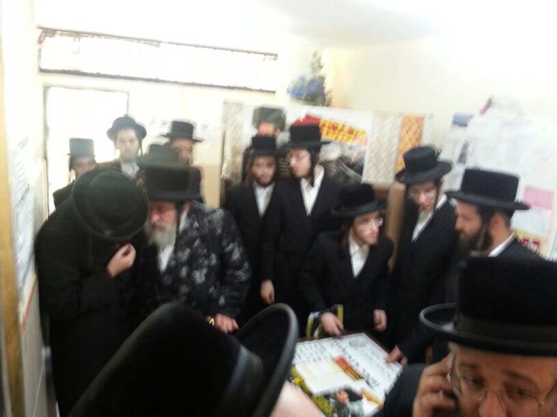 האדמו"ר בדוכן ההתרמה בכניסה לבית