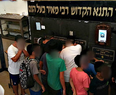 ילדי יד לאחים בתפילה בציון רבי מאיר בעל הנס.