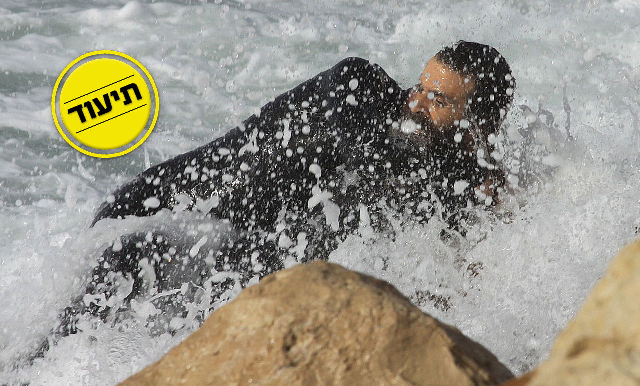 קידוש ה': החרדי קפץ למים עם החליפה - והציל את הגולש