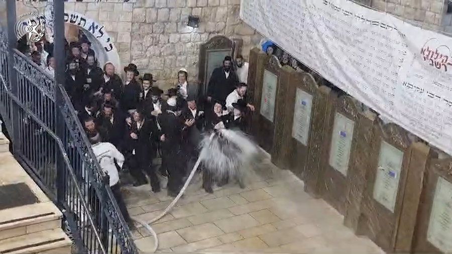 מתפללים משפריצים מים על שוטרים