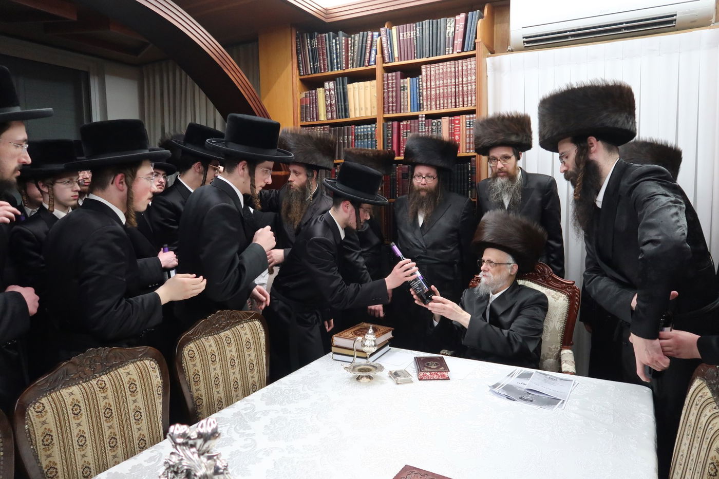 האדמו"ר מסערט ויז'ניץ בחלוקת יין לארבע כוסות למצטייני הישיבה 