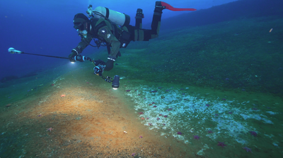 צוללן חוקר מוקד דליפה של גז מתאן באנטרטיקה