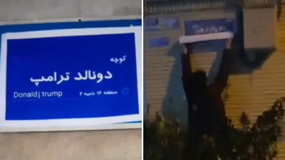 התושב תולה את השלט: "רחוב טרמאפ"