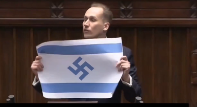 חרפה בפרלמנט הפולני: צלב קרס הונף בזמן ששורדי השואה צעדו באושוויץ