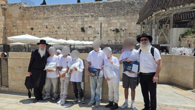 הניצולים חתני המצוות ברחבת הכותל המערבי השבוע, בחברת הרב זאב רובינסון והרב חיים קאהן, פעילי יד לאחים