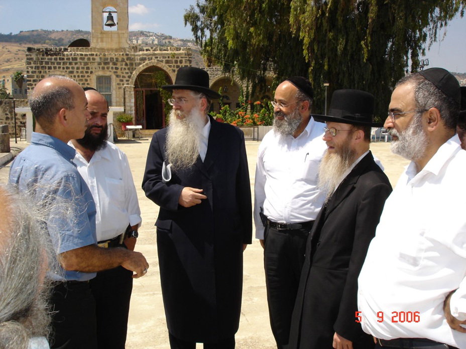 המשגיח הגה"צ רבי דן סגל בחצר הכנסייה האורתודוקסית בטבריה, שנבנתה על גבי בית כנסת כיפות השל"ה הק' בו התפלל האריז"ל. בצד שמאל ניתן לראות את הנזיר המקומי