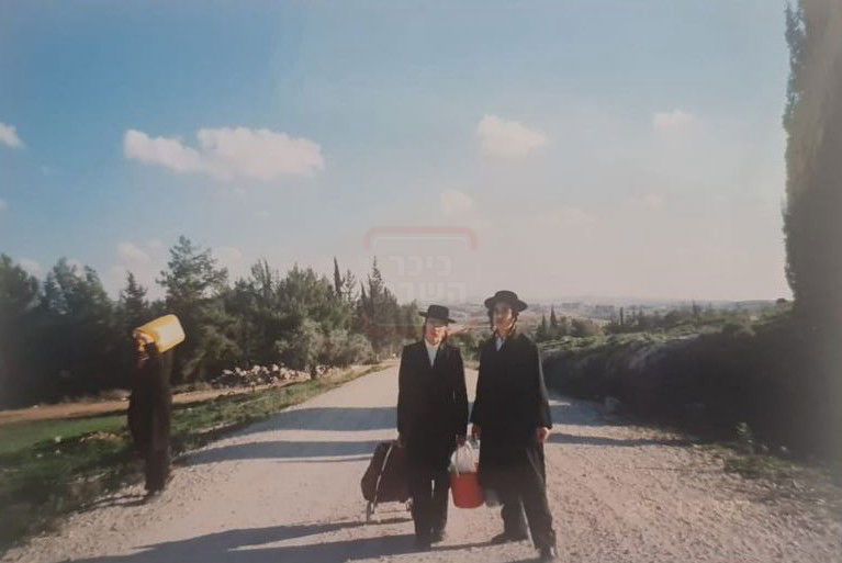 משה כהן ושלום פוקס ברקע נחמן לנגר עם מיכל מים להכנת הבטון למצבה